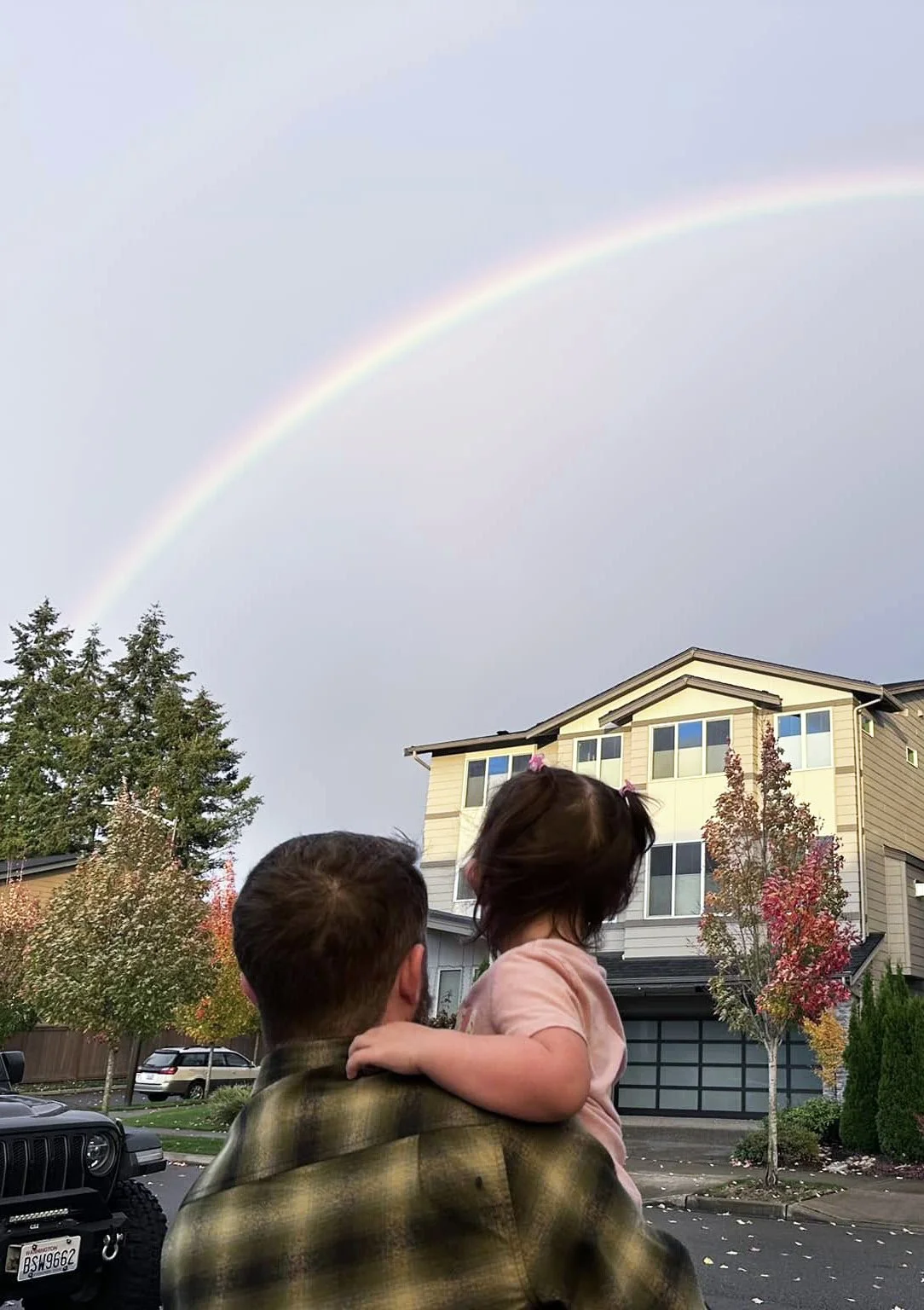 Jeff and his daughter Natalia looking at a rainbow over Woodinville